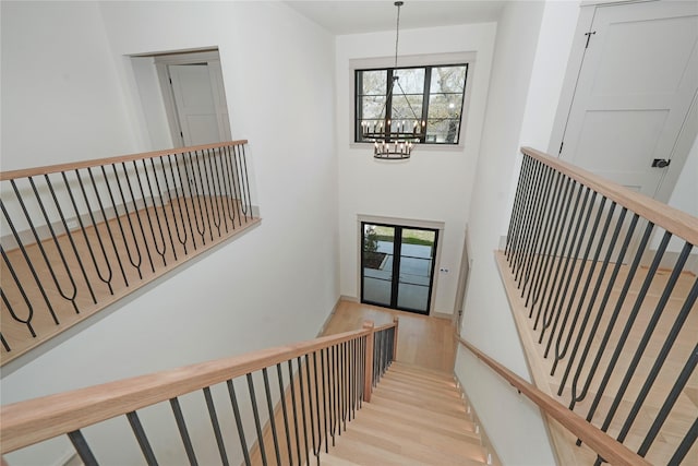 1253 Lamonte Ln, Houston, TX 77018 - stairway featuring a chandelier and wood finished floors