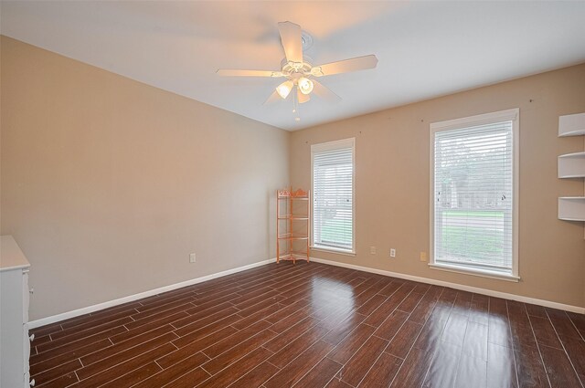 1214 Lindsey Dr, Rosenberg, TX 77471 - spare room with baseboards, dark wood-style flooring, and ceiling fan