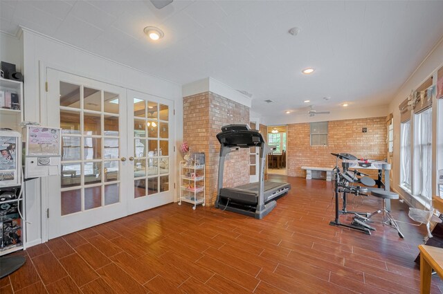 1214 Lindsey Dr, Rosenberg, TX 77471 - exercise area with wood finished floors, french doors, brick wall, a ceiling fan, and recessed lighting