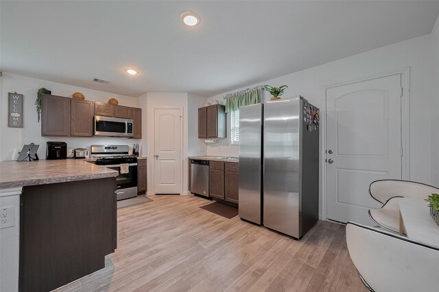 862 Rd 5138, Cleveland, TX 77327 - kitchen featuring appliances with stainless steel finishes, light wood-style flooring, dark brown cabinets, light countertops, and recessed lighting