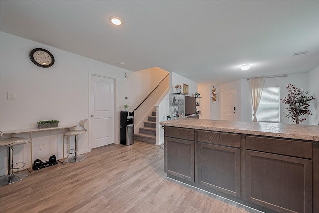 862 Rd 5138, Cleveland, TX 77327 - kitchen with light wood-style flooring, light countertops, and dark brown cabinetry