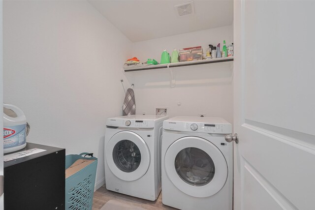 862 Rd 5138, Cleveland, TX 77327 - laundry room with washing machine and dryer and light wood-style flooring