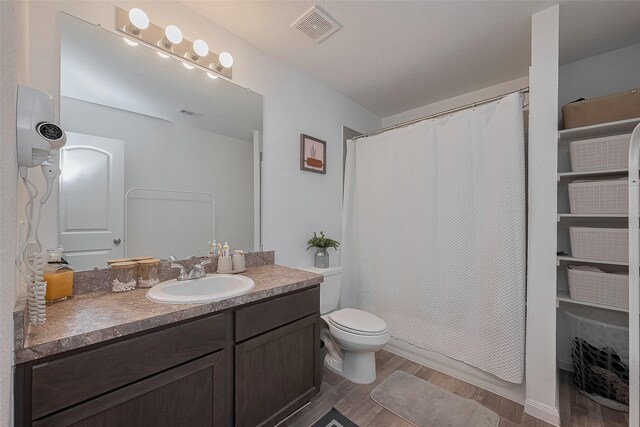 862 Rd 5138, Cleveland, TX 77327 - full bathroom featuring vanity, wood finished floors, toilet, and curtained shower