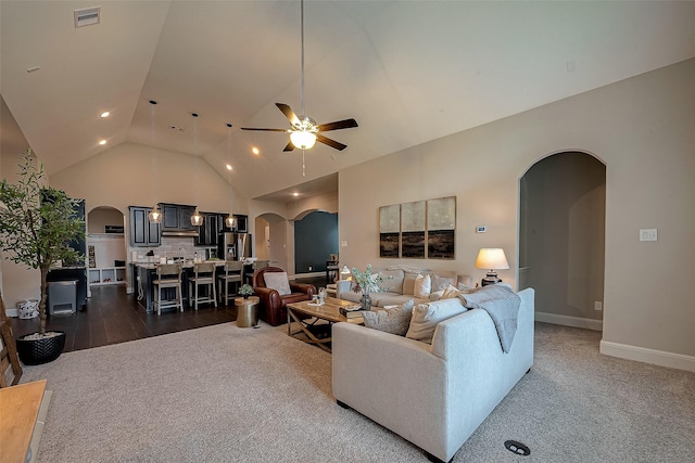 2625 Blooming Field Ln, Conroe, TX 77385 - living room with arched walkways, dark carpet, a ceiling fan, and high vaulted ceiling