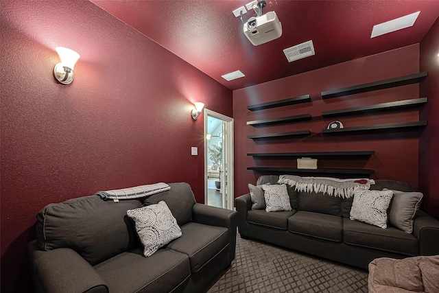 2625 Blooming Field Ln, Conroe, TX 77385 - home theater with vaulted ceiling, carpet flooring, a skylight, and a textured wall