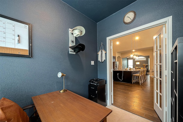 2625 Blooming Field Ln, Conroe, TX 77385 - office area with a textured wall, wood finished floors, and a chandelier