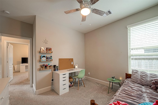 2625 Blooming Field Ln, Conroe, TX 77385 - home office with light carpet, a ceiling fan, and baseboards