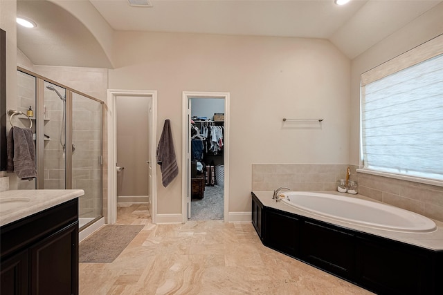 2625 Blooming Field Ln, Conroe, TX 77385 - full bathroom featuring vaulted ceiling, a garden tub, a shower stall, a spacious closet, and vanity