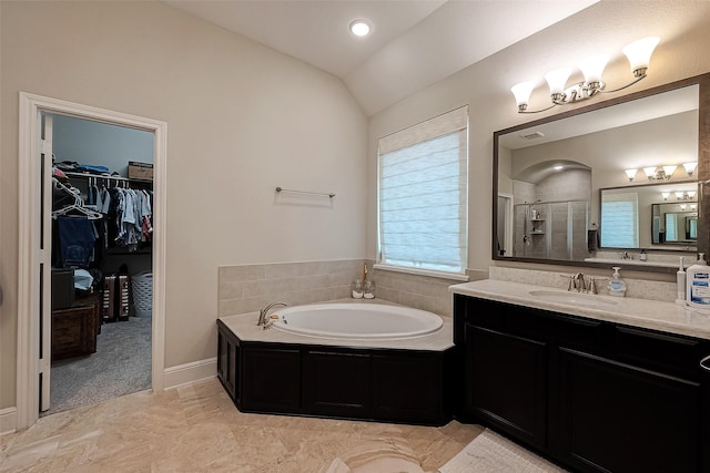 2625 Blooming Field Ln, Conroe, TX 77385 - bathroom with a stall shower, a bath, vanity, a walk in closet, and lofted ceiling