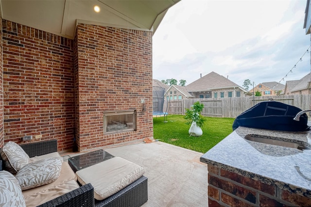 2625 Blooming Field Ln, Conroe, TX 77385 - view of patio featuring a trampoline, a sink, and a residential view