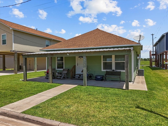 614 W 1st St, Freeport, TX 77541 - view of front of house featuring entry steps, roof with shingles, a front lawn, and central air condition unit