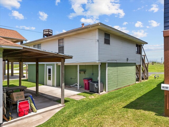 614 W 1st St, Freeport, TX 77541 - back of house with a patio area, a lawn, cooling unit, and stairs