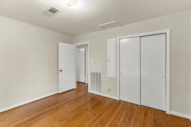 309 Helen Dr, Deer Park, TX 77536 - unfurnished bedroom featuring attic access, wood finished floors, and a closet