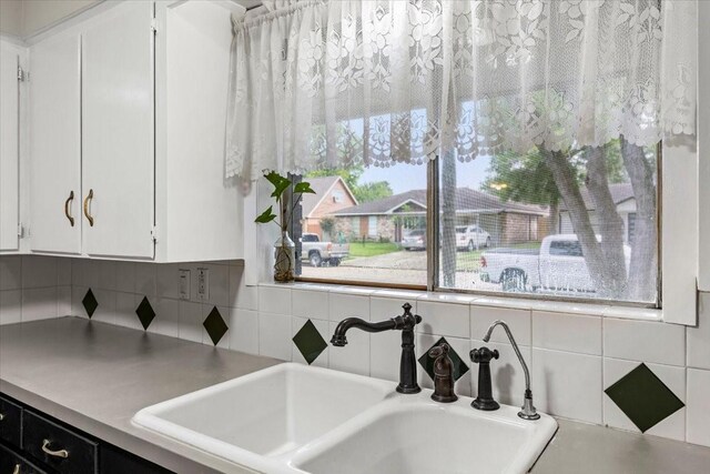 309 Helen Dr, Deer Park, TX 77536 - kitchen featuring tasteful backsplash, white cabinetry, and light countertops