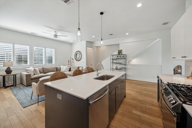 1234 W 25th St Unit A, Houston, TX 77008 - kitchen with a sink, dishwasher, gas range, light wood-style flooring, and recessed lighting