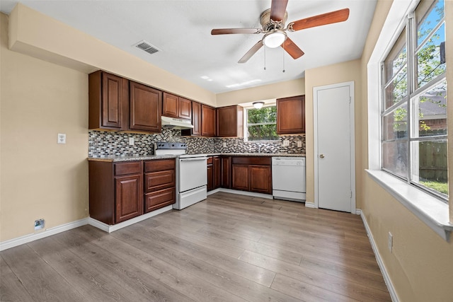 6639 Feather Creek Dr, Houston, TX 77086 - kitchen with white appliances, under cabinet range hood, decorative backsplash, light wood-style floors, and ceiling fan