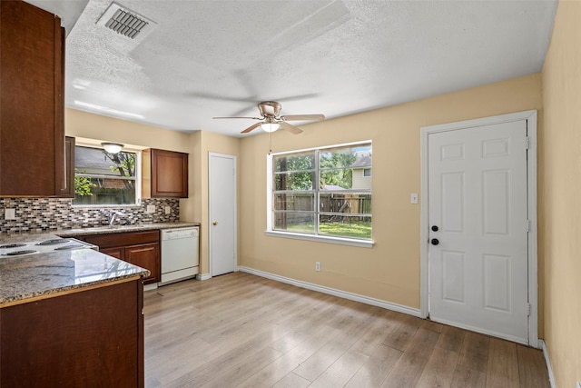 6639 Feather Creek Dr, Houston, TX 77086 - kitchen with dishwasher, a ceiling fan, decorative backsplash, baseboards, and light wood-type flooring