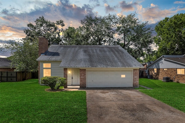 6639 Feather Creek Dr, Houston, TX 77086 - view of front of home with brick siding, driveway, central AC unit, and a chimney