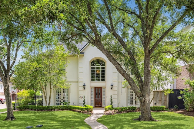 5301 Grand Lake St, Bellaire, TX 77401 - traditional-style house featuring stucco siding and french doors