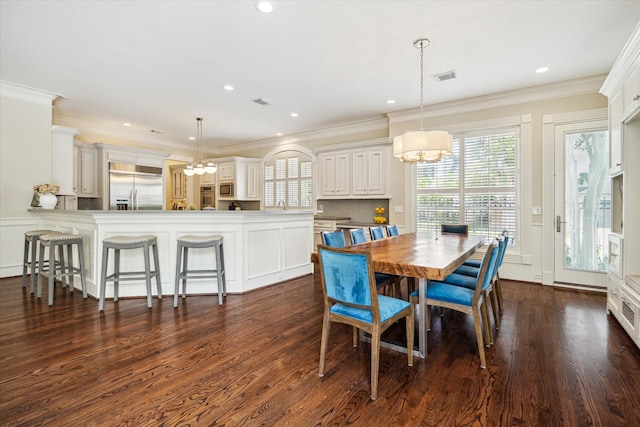 5301 Grand Lake St, Bellaire, TX 77401 - dining space with a chandelier, dark wood finished floors, ornamental molding, and recessed lighting
