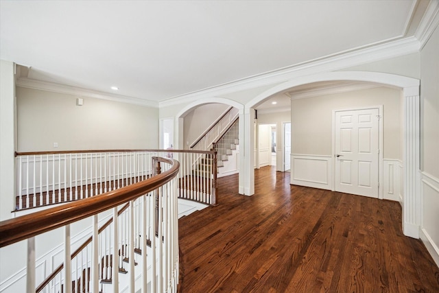 5301 Grand Lake St, Bellaire, TX 77401 - hallway with crown molding, wood finished floors, arched walkways, recessed lighting, and a wainscoted wall