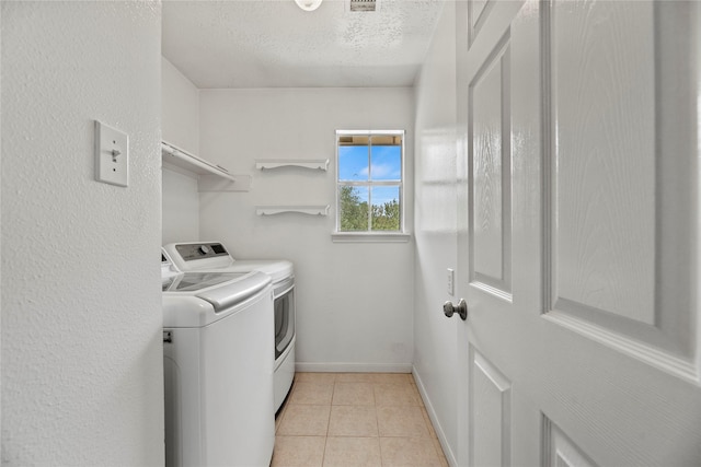 4131 N New Meadows Dr, Sugar Land, TX 77479 - washroom featuring separate washer and dryer, a textured ceiling, baseboards, and light tile patterned floors