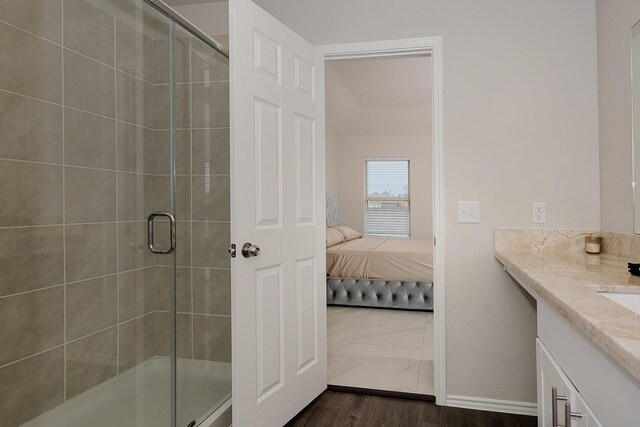 309 Cumberland Forest Dr, Magnolia, TX 77354 - ensuite bathroom featuring vanity, a shower stall, baseboards, and wood finished floors