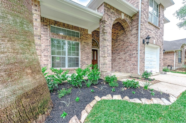 5732 Montclair Hill Ln, Rosharon, TX 77583 - doorway to property featuring a garage, brick siding, and covered porch