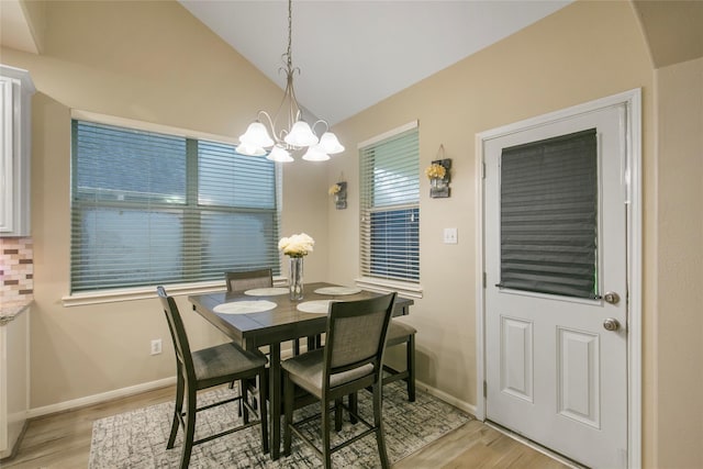 5732 Montclair Hill Ln, Rosharon, TX 77583 - dining area with light wood-style flooring, vaulted ceiling, and a chandelier