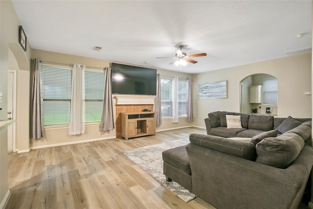 5732 Montclair Hill Ln, Rosharon, TX 77583 - living area featuring arched walkways, a ceiling fan, and light wood-style floors