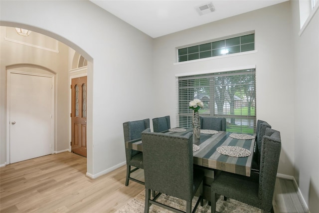 5732 Montclair Hill Ln, Rosharon, TX 77583 - dining space featuring arched walkways and wood finished floors