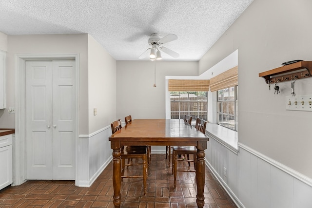 457 Monticello Park, Conroe, TX 77302 - dining area with ceiling fan, brick patterned floors, a textured ceiling, and baseboards