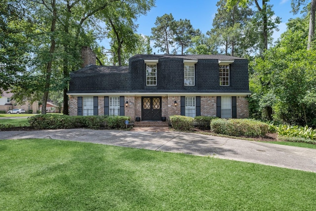 457 Monticello Park, Conroe, TX 77302 - view of front of property with brick siding, a shingled roof, and a front lawn