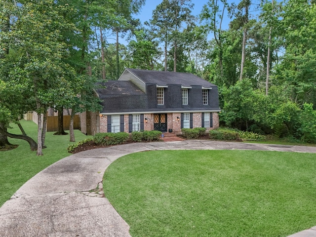 457 Monticello Park, Conroe, TX 77302 - view of front facade featuring brick siding, a shingled roof, and a front lawn