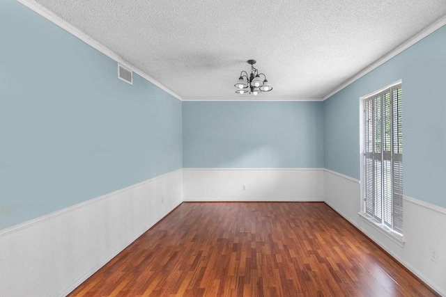 457 Monticello Park, Conroe, TX 77302 - spare room with a chandelier, wood finished floors, a textured ceiling, and ornamental molding