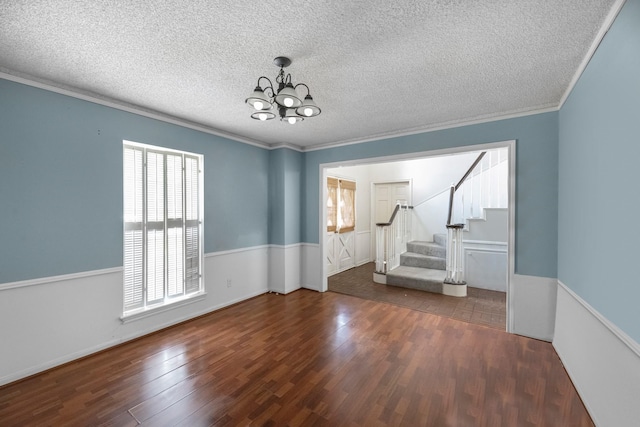 457 Monticello Park, Conroe, TX 77302 - unfurnished room with a chandelier, wood finished floors, stairway, crown molding, and a textured ceiling