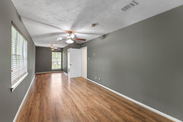 457 Monticello Park, Conroe, TX 77302 - unfurnished room with a ceiling fan, wood finished floors, baseboards, and a textured ceiling