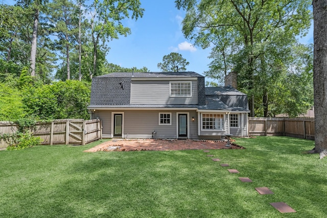 457 Monticello Park, Conroe, TX 77302 - rear view of property featuring a chimney and roof with shingles