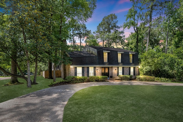 457 Monticello Park, Conroe, TX 77302 - colonial inspired home with brick siding, a front yard, and driveway