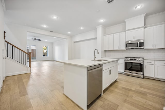 1108 Dart St, Houston, TX 77007 - kitchen with stainless steel appliances, a sink, ornamental molding, decorative backsplash, and light countertops