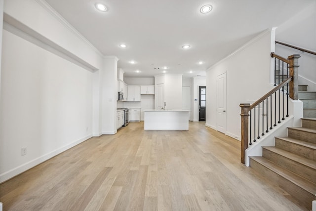 1108 Dart St, Houston, TX 77007 - unfurnished living room featuring crown molding, recessed lighting, baseboards, stairs, and light wood-style floors