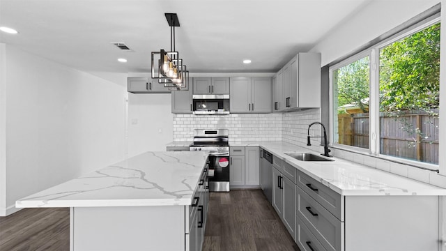 8603 Twisting Vine Ln, Houston, TX 77040 - kitchen with stainless steel appliances, a sink, gray cabinetry, dark wood-type flooring, and recessed lighting