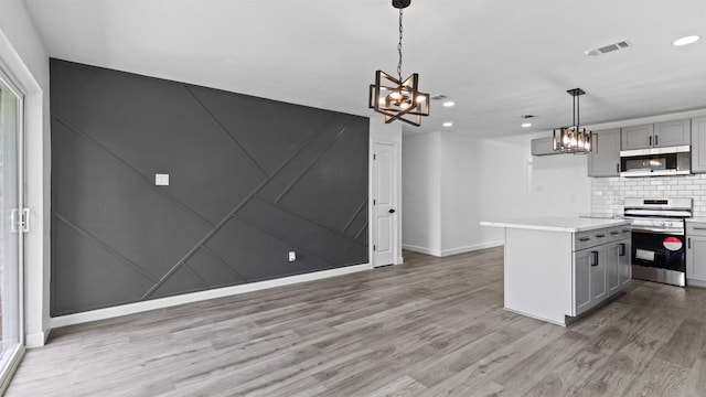 8603 Twisting Vine Ln, Houston, TX 77040 - kitchen featuring appliances with stainless steel finishes, gray cabinets, a chandelier, recessed lighting, and light wood finished floors