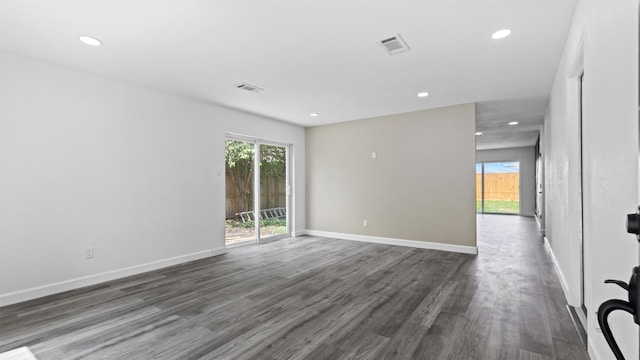 8603 Twisting Vine Ln, Houston, TX 77040 - spare room featuring dark wood-type flooring, recessed lighting, and baseboards