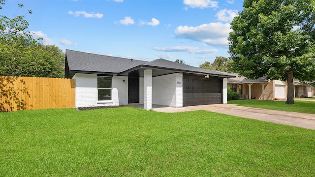 8603 Twisting Vine Ln, Houston, TX 77040 - mid-century modern home featuring an attached garage, concrete driveway, a shingled roof, and brick siding