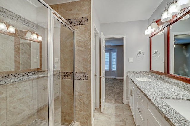 7112 Ave L, Houston, TX 77011 - bathroom featuring a stall shower, double vanity, baseboards, and tile patterned flooring
