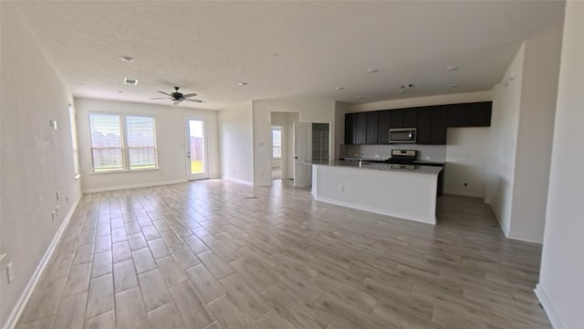 4322 Mossy Banks Ln, Houston, TX 77068 - unfurnished living room with baseboards, ceiling fan, and light wood-style floors