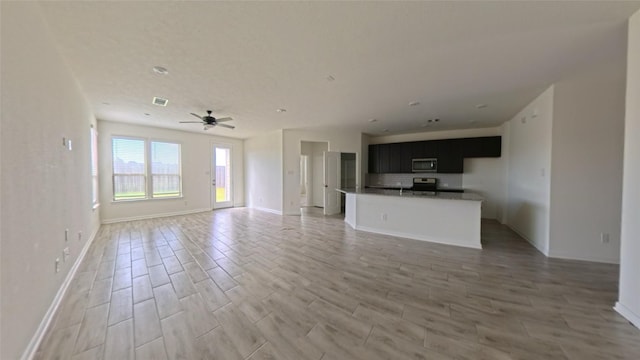 4322 Mossy Banks Ln, Houston, TX 77068 - unfurnished living room featuring ceiling fan, light wood finished floors, and baseboards