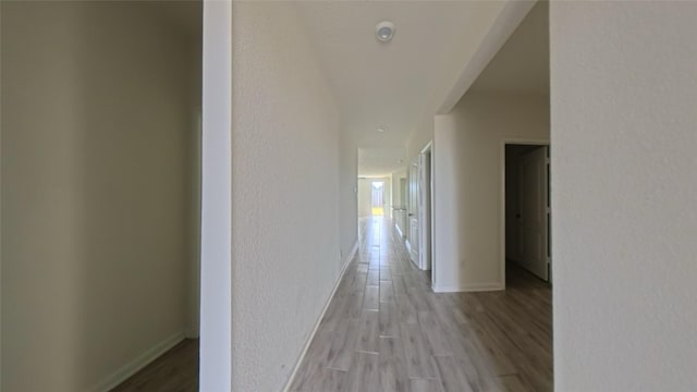 4322 Mossy Banks Ln, Houston, TX 77068 - hall featuring light wood finished floors, baseboards, and a textured wall