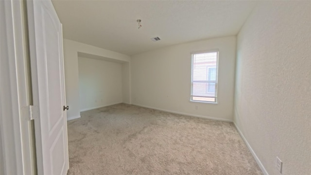 4322 Mossy Banks Ln, Houston, TX 77068 - empty room featuring light colored carpet, baseboards, and a textured wall
